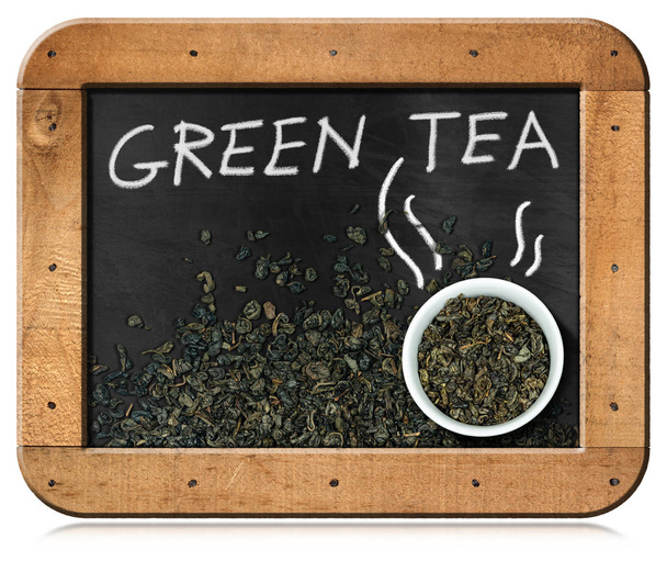 Tabule se sušenými listy zeleného čaje a šálku - izolovaná na bílém - Fotografie, Obrázek