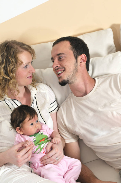 indoor portrait with happy young family and  cute little babby  - Photo, Image