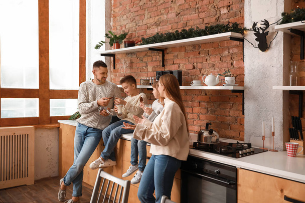 Happy family resting together in kitchen - Photo, Image