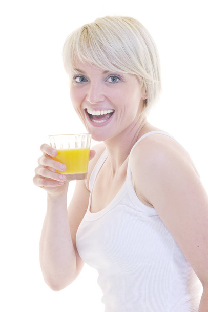 happy Young blonde woman drinking orange juice isolated over white background - Fotografie, Obrázek