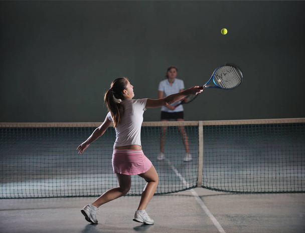 young girls playing tennis game indoori in tennis court - Photo, image