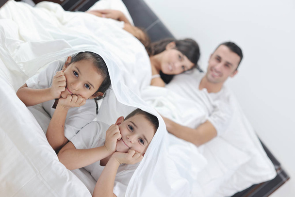 happy young Family in their bedroom have fun and play in bed - Fotoğraf, Görsel