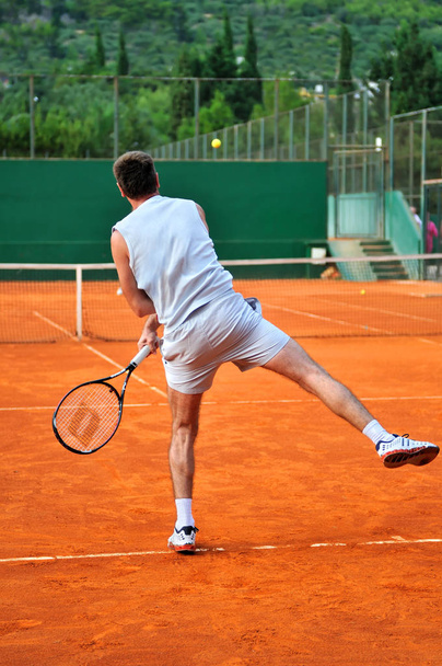 One man play tennis on outdoor court - Fotó, kép