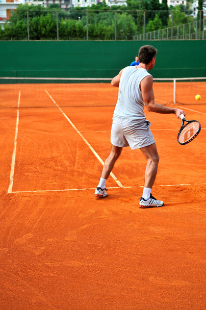 One Man play tennis on outdoor court - Φωτογραφία, εικόνα