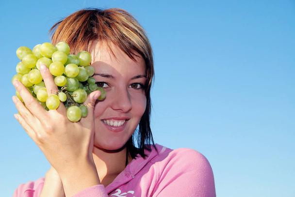 girl with grape outdoor - Photo, image