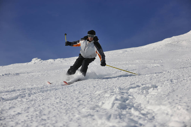 skier free ride downhill at winter season on beautiful sunny day  - Фото, зображення