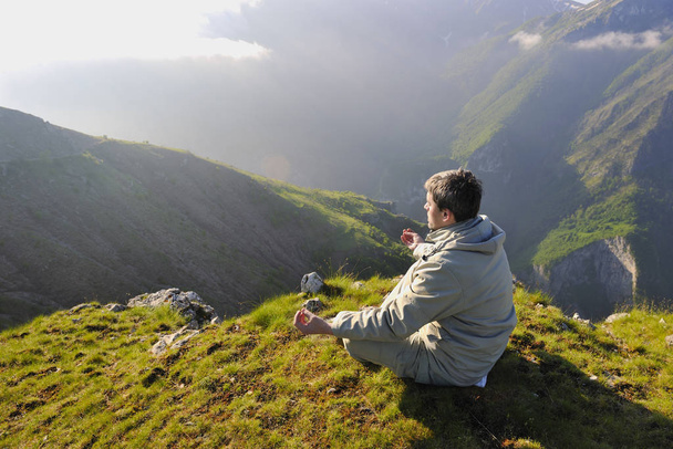 healthy young man practice youga in height mountain at early morning and sunrise - 写真・画像