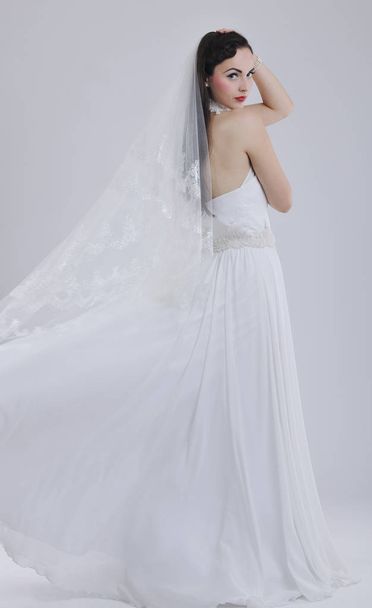 beautiful young bride wearing  wedding dress in retro fashion style isolated on white background in studio - Valokuva, kuva