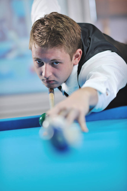 young pro billiard player finding best solution and right angle at billard or snooker pool sport  game  - Foto, afbeelding