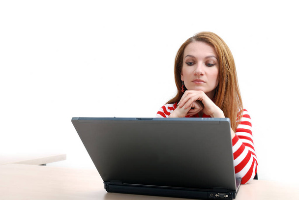 woman in red working on laptop at bright  office - Foto, Imagem
