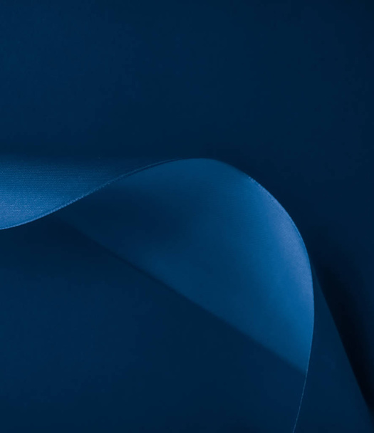 Abstract silk ribbon on royal blue background, exclusive luxury  - Фото, зображення