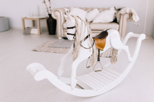 Baby room in white scandinavian style with rocking horse - Photo, Image