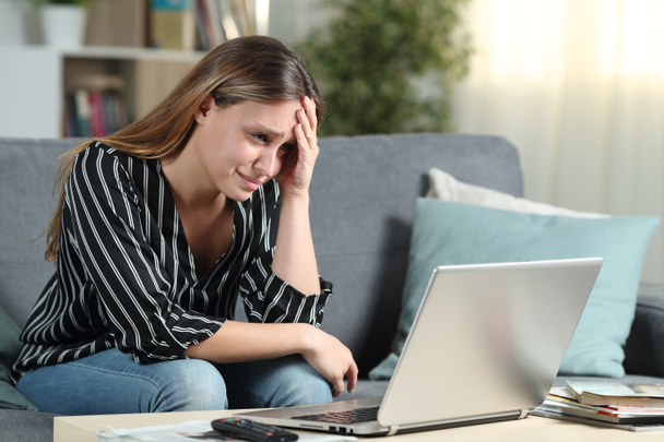 Worried homeowner checks laptop news - Fotó, kép