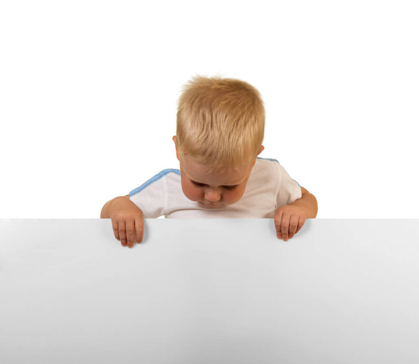 Little boy looking at big blank banner, isolated on white - Foto, Bild