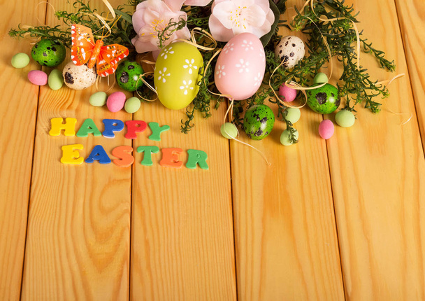 Eggs, candy, flowers, butterfly, words HAPPY EASTER - Photo, Image