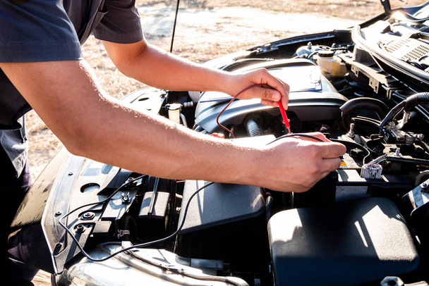 The hands of the repairman are checking the order of the engine using modern tools - Photo, Image