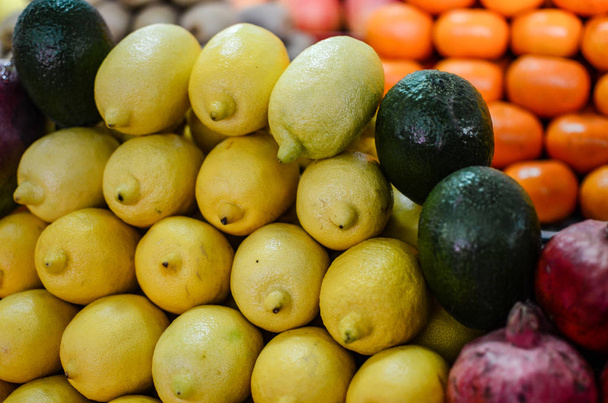 cytryny awokado mandarynki granaty na rynku - Zdjęcie, obraz