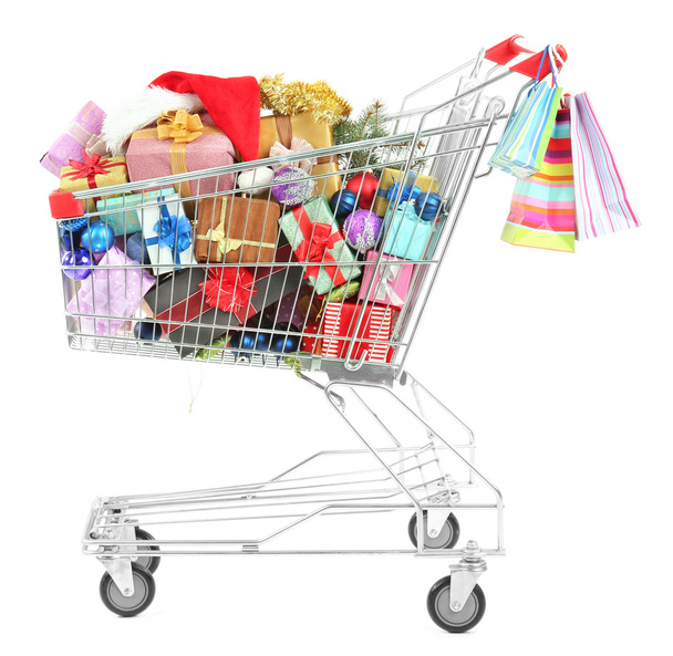 Christmas gifts in shopping trolley, isolated on white - Foto, immagini