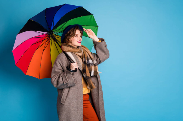 Hi. Profile photo of pretty traveler lady hold colorful parasol walking street meet old friend wear stylish casual long grey coat jumper pants hat scarf isolated blue color background - Foto, Bild