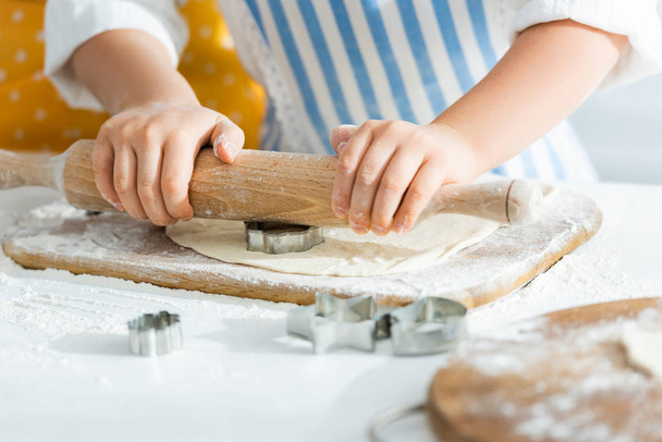 cropped view of kid rolling dough with rolling pin - Photo, Image