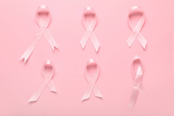 Pink ribbons on color background. Breast cancer awareness concept - Photo, Image