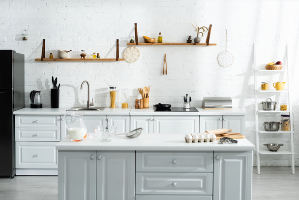 interior of kitchen with cooking utensils, food, milk and kitchenware - Foto, Bild