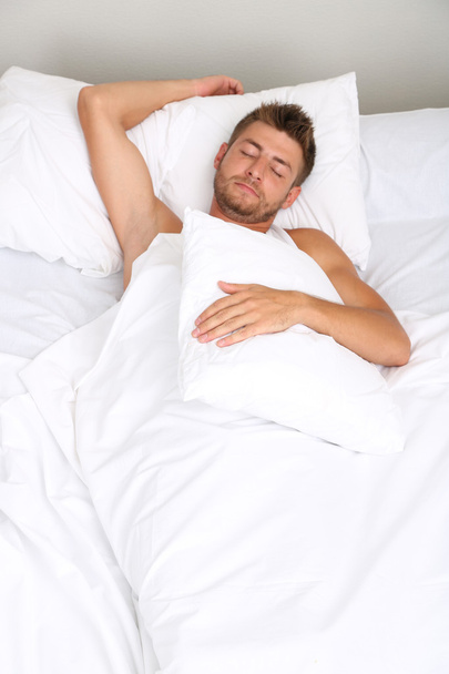 Handsome young man in bed - Photo, Image