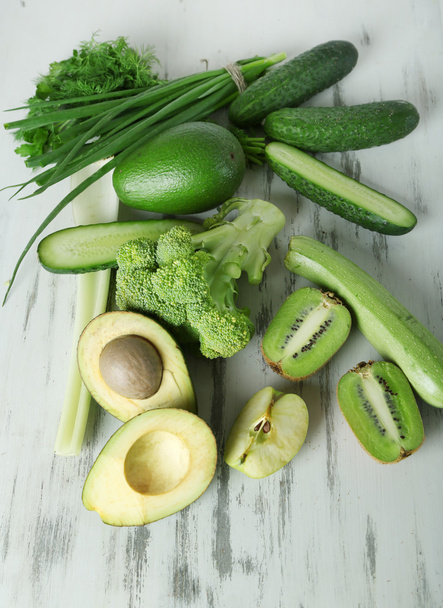 Fresh green vegetables and fruits, on wooden background - Foto, Bild