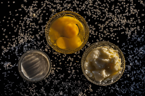 Close up shot of ayurvedic method or calcium supplement on the black surface consisting of raw eggs, milk, and ghee or clarified butter along with some sugar as a sweetener. - 写真・画像