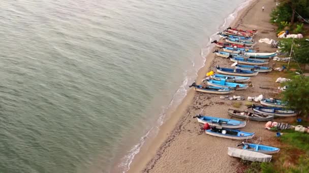 Small angling boats are dry docked on the beach.Above view on fishing boats that are dry docked, withdrawn at the sandy beach, coastline. H.264 video codec - Footage, Video