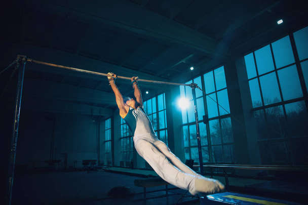 Little male gymnast training in gym, flexible and active - 写真・画像