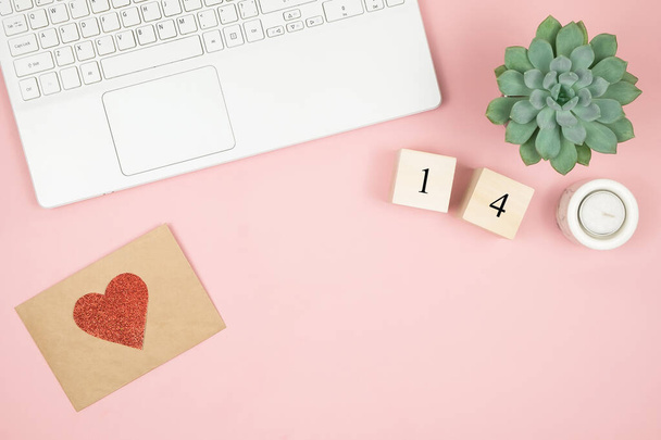 Composition for Valentines Day February 14th. Delicate pink background, laptop and cosmetics. Greeting card. Flat lay, top view, copy space. - Photo, Image