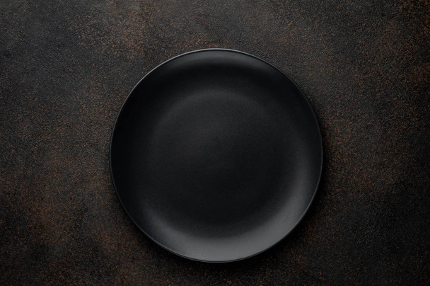 black plate on a stone background - Photo, Image