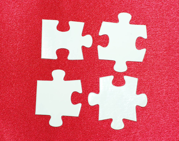 White puzzles isolated on a red - Fotoğraf, Görsel