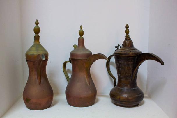Арабские традиционные старинные предметы старины. Латунный кофейник, чашки, тарелки и подносы
. - Фото, изображение