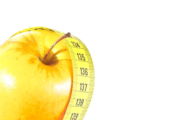 measuring tape around yellow apple with space for text, diet concept - Fotó, kép