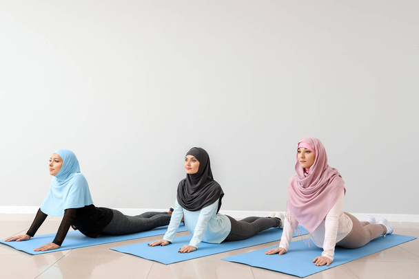体育館でヨガを練習するスポーティムスリム女性 - 写真・画像
