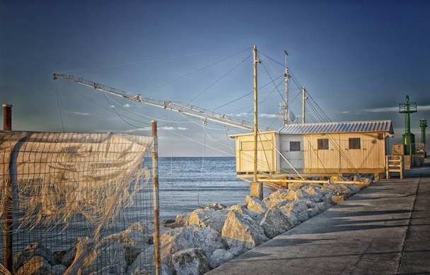 Fishing hut in the harbour channel of Cervia in Northern Italy on the Adriatic Sea - Fotoğraf, Görsel