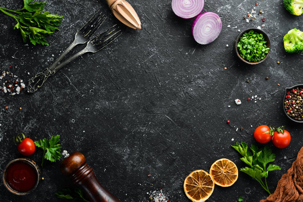 Black food background. Vegetables and spices on black background. Top view. Free space for your text. - Φωτογραφία, εικόνα