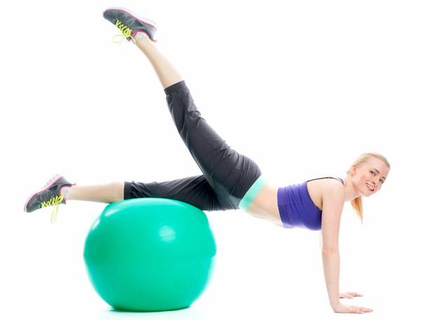 blond girl exercising with fitness ball - Foto, Imagen