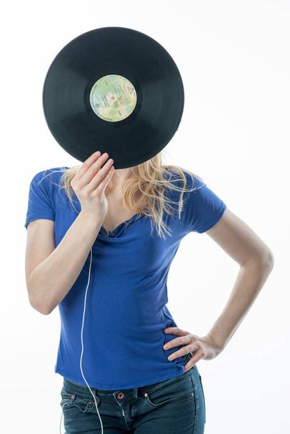 blonde girl hiding behind a record - Fotoğraf, Görsel