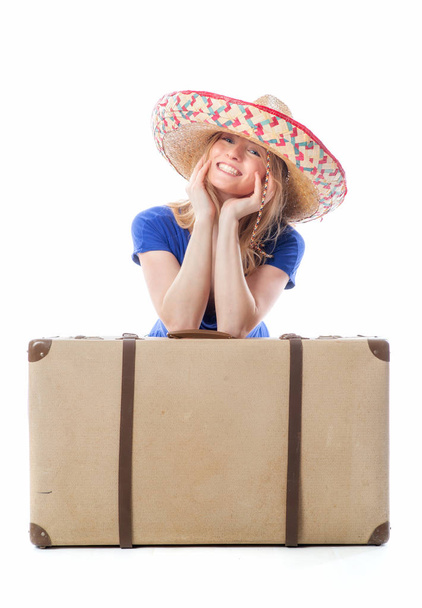blond girl sitting behind a suitcase - Фото, изображение