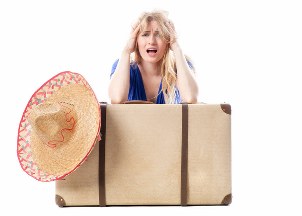 blond girl sitting behind a travel suitcase - Фото, изображение