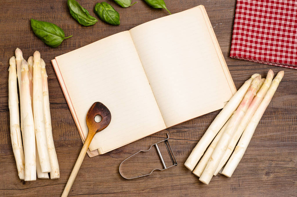 book with copy space,wooden spoon,asparagus,basil,napkin and peeler - Foto, immagini