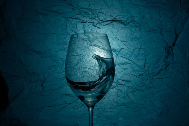 Holded water splash in wineglass - Photo, Image
