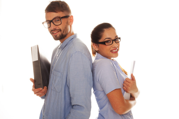 Nerdy couple holding files in a white background - Foto, Imagem