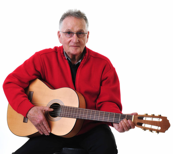 sprightly pensioner playing guitar - Фото, зображення