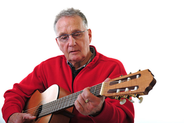 sprightly pensioner playing guitar - Фото, изображение