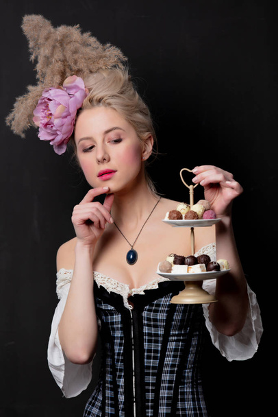Beautiful blonde countess with chocolate candies  - Photo, Image