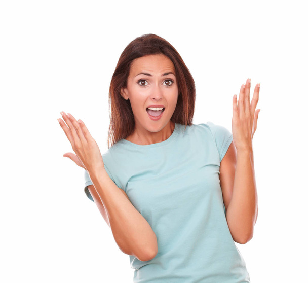 Portrait of cute adult woman on blue t-shirt screaming and looking at you with funny face on isolated white background - copyspace - Φωτογραφία, εικόνα